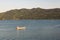 Man in boat relaxing and fishing on Danube river on a sunny day in Orsova, Romania, 2020