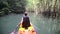 man boating in kayak along lagoon