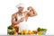 Man bodybuilder cook with apple on biceps