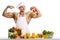 Man bodybuilder cook with apple on biceps