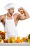 Man bodybuilder cook with apple on biceps