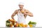 Man bodybuilder cook, cooking freshly squeezed juice and vegetables salad