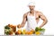 Man bodybuilder cook, cooking freshly squeezed juice and vegetables salad