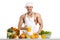Man bodybuilder cook, cooking freshly squeezed juice and vegetables salad