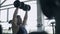 Man bodybuilder execute exercise with dumbbells in gym. Profile of face shot