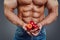 Man bodybuilder hands holding a fresh peaches