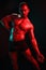 Man bodybuilder posing muscles with nude fitness torso, isolated on black background in neon light. Advertising, sports