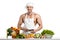 Man bodybuilder in white toque blanche and cook protective apron