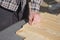 Man is bolting screwed into a wooden board.