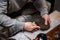 A man bought a set of milking tea ceremony at home and breaks off a piece of raw puerh tea cake with a needle to brew a