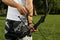 Man with bow and arrow practicing archery in park