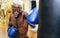 Man boxer training hard - Young black guy boxing in sport gym center club