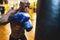 Man boxer training hard - Young black guy boxing in sport gym center club