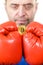 Man in boxing gloves holding bitcoin