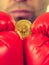 Man in boxing gloves holding bitcoin