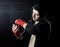 Man in boxing hoodie jumper with hood on head wrapping hands and wrists getting ready for fighting