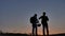 Man and boy drinking bottle of water on travel silhouette sunlight sunrise.traveler and tourist on the mountain