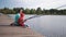 Man and boy fishing on pier