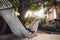 Man with boy lounging in hammock