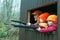 Man and boys looking out of deer stand with guns