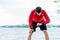 Man at break from running in front of lake