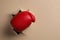 Man breaking through beige paper with boxing glove, closeup. Space for text