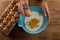 Man breaking eggs in the flour in bowl