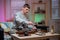 A man brews chinese tea according to an old oriental recipe on a bamboo gongfu tray. Adds boiling water from the teapot