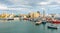 Man brings his sailboat dead slow into Port Vell Marina in Barcelona, Spain.