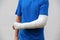 Man with broken arm wrapped medical cast plaster. Fiberglass cast covering the wrist, arm, elbow after sport accident, isolated on