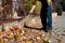 Man brooming the street to collect fallen leaves