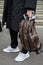 Man with brown Louis Vuitton backpack and black padded jacket before Frankie Morello fashion show