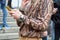 Man with brown snake leather print shirt and Rolex Submariner watch looking at smartphone before