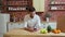 Man browsing on mobile phone at home kitchen. Handsome young man browsing on smartphone smiling happy.