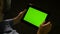 Man browsing on tablet pc with green screen