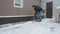 Man Brushing Snow Shovel 5