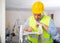 Man builder examining project documentation in apartment