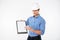 Man building engineer in hard hat pointing on blank clipboard