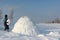 Man building an igloo in a blizzard