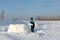 Man building an igloo of snow blocks