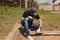 Man builds sections of fence around his yard out of planks