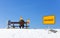 Man with burnout and burning head on wooden bench in winter