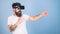 Man with bushy beard in VR glasses using digital touch screen interface. Macho with hipster beard frightened of