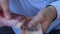 A man in a business shirt counting Bolivia money. Lots of different banknotes