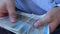 A man in a business shirt counting Polish money. A large amount of the highest value banknotes, 500 zlotys