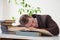 A man in a business suit fell asleep at a desk