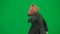 Man in business suit with horse head mask on green studio background. Businessman walking, bouncing and dancing. Concept