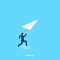 Man in a business suit launches a paper plane