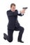 man in business suit sitting on knee and shooting with gun isolated on white