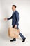 Man in Business Suit Walking with Craft Paper Bag in Hand, Recycle material, Shopping, Discount and sale, Template, Delivery